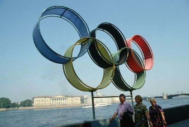 Russian Tourists Posing Below the Olympic Rings