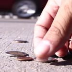 man collect coins on street concrete